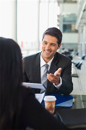 smiling businessman in office - Business people working together in cafe Stock Photo - Premium Royalty-Free, Code: 649-06040602