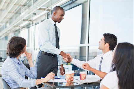 Business people shaking hands in cafe Stock Photo - Premium Royalty-Free, Code: 649-06040612