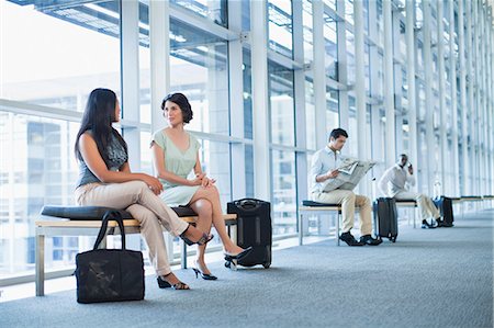 sitting crossed legs man - Business people talking in hallway Stock Photo - Premium Royalty-Free, Code: 649-06040654