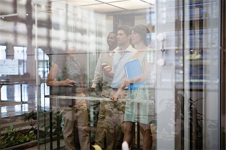 Business people riding glass elevator Stock Photo - Premium Royalty-Free, Code: 649-06040667