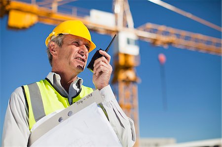 engineers technical talking - Worker using walkie talkie on site Stock Photo - Premium Royalty-Free, Code: 649-06040716