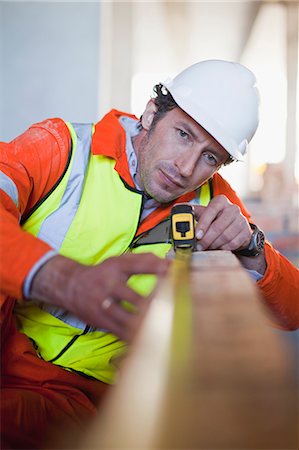 engineers inspecting at construction site - Worker measuring brick on site Stock Photo - Premium Royalty-Free, Code: 649-06040761