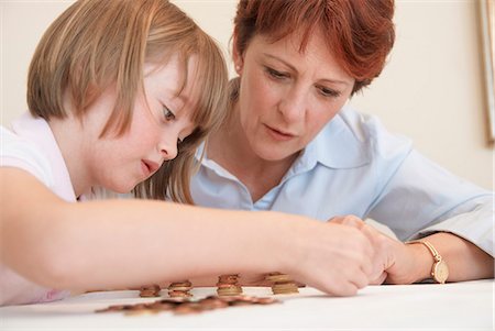 family in rain - Mother and daughter counting coins Stock Photo - Premium Royalty-Free, Code: 649-06040947