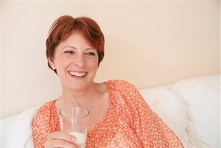 Smiling woman drinking glass of milk Fotografie stock - Premium Royalty-Free, Codice: 649-06040959