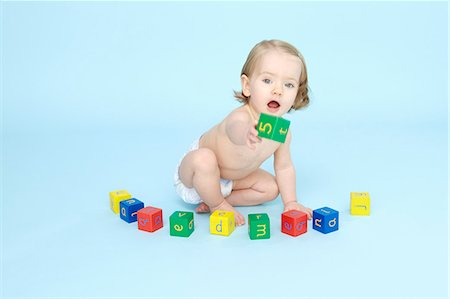 Baby girl playing with colored blocks Stock Photo - Premium Royalty-Free, Code: 649-06040982