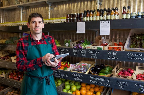 Grocer using tablet computer in store Stock Photo - Premium Royalty-Free, Image code: 649-06041012