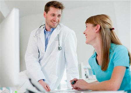 doctor office happy - Doctor talking to receptionist in office Stock Photo - Premium Royalty-Free, Code: 649-06041125