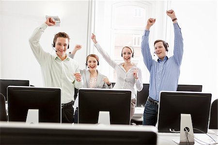 Business people cheering in headsets Stock Photo - Premium Royalty-Free, Code: 649-06041214