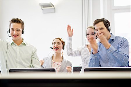 Business people cheering in headsets Stock Photo - Premium Royalty-Free, Code: 649-06041253