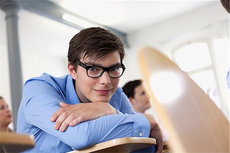 portrait eye contact male caucasian not female - Businessman resting chin on arms Stock Photo - Premium Royalty-Free, Code: 649-06041273