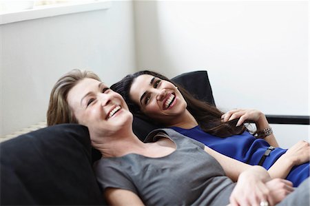 friends women indoors happy middle aged - Smiling women relaxing on sofa Stock Photo - Premium Royalty-Free, Code: 649-06041346