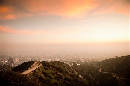 sunrise and city - Aerial view of rural mountain road Stock Photo - Premium Royalty-Free, Code: 649-06041493