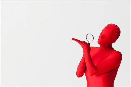 Woman in bodysuit with magnifying glass Stock Photo - Premium Royalty-Free, Code: 649-06041647