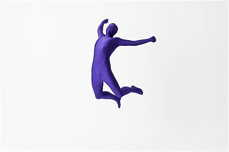Man in bodysuit jumping for joy Stock Photo - Premium Royalty-Free, Code: 649-06041654
