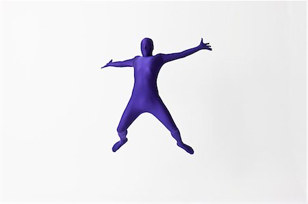 Man in bodysuit jumping for joy Fotografie stock - Premium Royalty-Free, Codice: 649-06041651