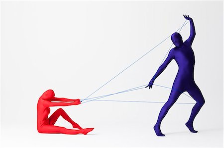 dependency - Couple in bodysuits playing with string Stock Photo - Premium Royalty-Free, Code: 649-06041688