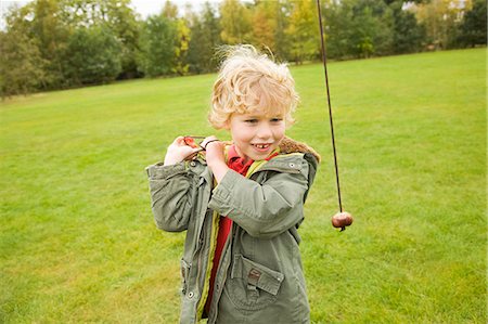 Boy playing with chestnut on string Stock Photo - Premium Royalty-Free, Code: 649-06041804