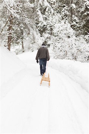 simsearch:649-03817453,k - Man pulling sled in snowy field Stock Photo - Premium Royalty-Free, Code: 649-06041846