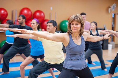 simsearch:6122-07706535,k - People practicing yoga in studio Stock Photo - Premium Royalty-Free, Code: 649-06042044