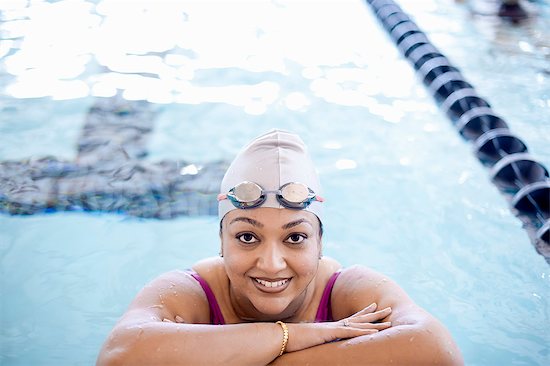 Woman at edge of swimming pool Stock Photo - Premium Royalty-Free, Image code: 649-06042077