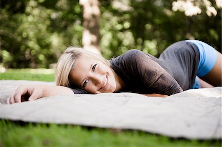Woman laying on blanket in park Stock Photo - Premium Royalty-Free, Code: 649-06112540
