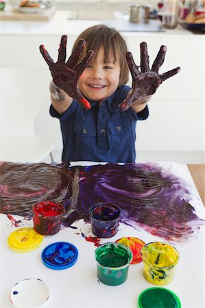 a child painting with finger paints, Stock image