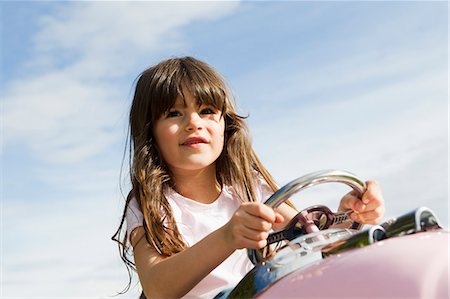 Girl driving toy airplane in field Stock Photo - Premium Royalty-Free, Code: 649-06112627