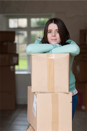 Teenage girl leaning on cardboard box Stock Photo - Premium Royalty-Free, Code: 649-06112652