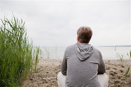 peaceful human - Man sitting on sandy beach Stock Photo - Premium Royalty-Free, Code: 649-06112667