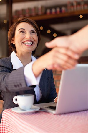 simsearch:649-06040125,k - Business people shaking hands in cafe Stock Photo - Premium Royalty-Free, Code: 649-06112754