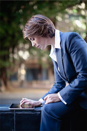Businesswoman using tablet computer Stock Photo - Premium Royalty-Free, Code: 649-06112767