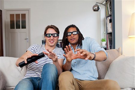simsearch:649-06112949,k - Men watching 3D television together Stock Photo - Premium Royalty-Free, Code: 649-06112946
