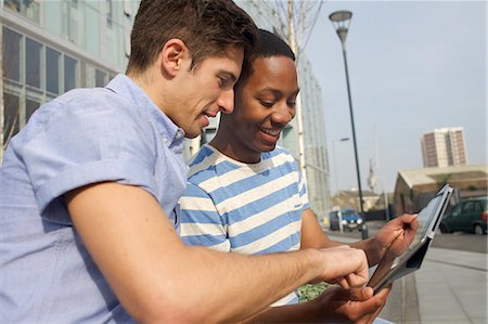 friends tablet - Men using tablet computer on street Stock Photo - Premium Royalty-Free, Code: 649-06113013