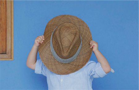 sunhat - Boy playing with fathers hat Stock Photo - Premium Royalty-Free, Code: 649-06113161