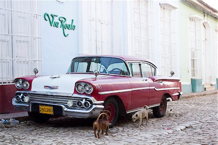 photography of old car - Dogs examining vintage car on street Stock Photo - Premium Royalty-Free, Code: 649-06113214