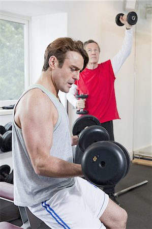 Man lifting weights in gym Stock Photo - Premium Royalty-Free, Code: 649-06113456
