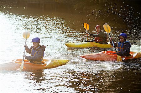 simsearch:649-06113549,k - Kayakers rowing together on still lake Stock Photo - Premium Royalty-Free, Code: 649-06113539