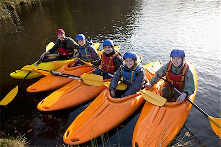 eye contact man portrait - Kayakers lined up in still lake Stock Photo - Premium Royalty-Free, Code: 649-06113547