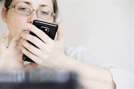 person receiving text message - Businesswoman using cell phone Stock Photo - Premium Royalty-Free, Code: 649-06113726