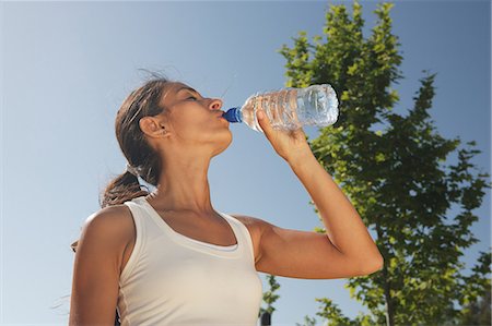 Woman drinking water outdoors Stock Photo - Premium Royalty-Free, Code: 649-06113784