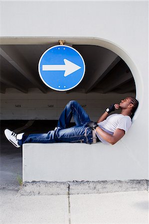 direction - Man sitting on ledge on city street Stock Photo - Premium Royalty-Free, Code: 649-06164487