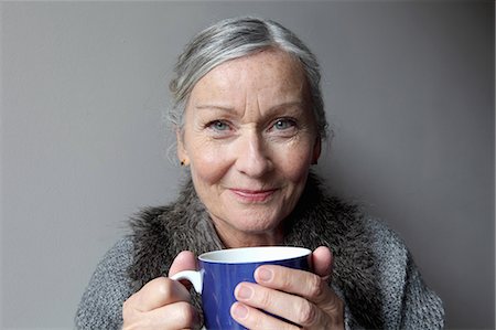 portrait, grey background - Older woman drinking coffee indoors Stock Photo - Premium Royalty-Free, Code: 649-06164524