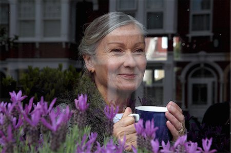 Woman drinking coffee at window Stock Photo - Premium Royalty-Free, Code: 649-06164522