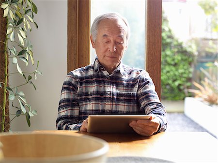 reading and tablet - Older man using tablet computer Stock Photo - Premium Royalty-Free, Code: 649-06164554