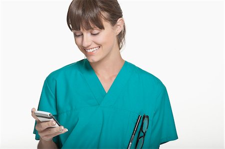 people reading cutout - Smiling surgeon using cell phone Stock Photo - Premium Royalty-Free, Code: 649-06164643