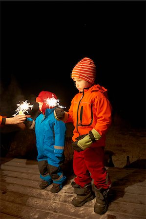 Boys playing with sparkler outdoors Stock Photo - Premium Royalty-Free, Code: 649-06164684