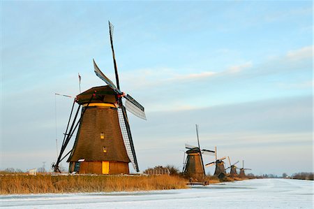 Windmills by frozen rural lake Fotografie stock - Premium Royalty-Free, Codice: 649-06164872