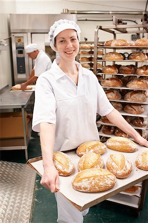 freshly baked bread - Chef carrying tray of bread in kitchen Stock Photo - Premium Royalty-Free, Code: 649-06165026