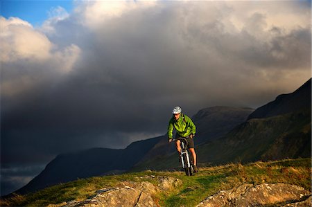 extreme - Mountain biker on grassy hillside Stock Photo - Premium Royalty-Free, Code: 649-06165062