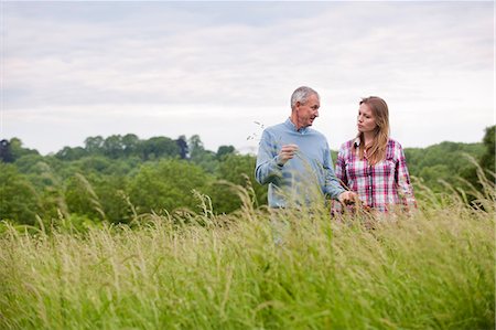 parent teaching outdoor - Father and daughter in tall grass Stock Photo - Premium Royalty-Free, Code: 649-06304855